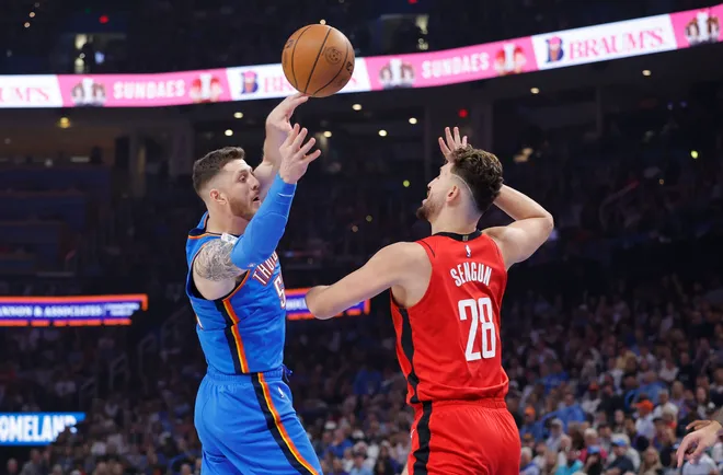 Oct 21, 2025; Oklahoma City, Oklahoma, USA; Oklahoma City Thunder center Isaiah Hartenstein (55) passes around Houston Rockets center Alperen Sengun (28) during the first half at Paycom Center. Mandatory Credit: Alonzo Adams-Imagn Images