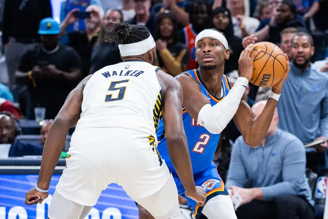 Oct 23, 2025; Indianapolis, Indiana, USA; Oklahoma City Thunder guard Shai Gilgeous-Alexander (2) holds the ball while Indiana Pacers forward Jarace Walker (5) defends in the second half at Gainbridge Fieldhouse. Mandatory Credit: Trevor Ruszkowski-Imagn Images