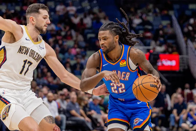 Nov 17, 2025; New Orleans, Louisiana, USA; Oklahoma City Thunder guard Cason Wallace (22) dribbles against New Orleans Pelicans forward/center Karlo Matković (17) during the first half at Smoothie King Center. Mandatory Credit: Stephen Lew-Imagn Images