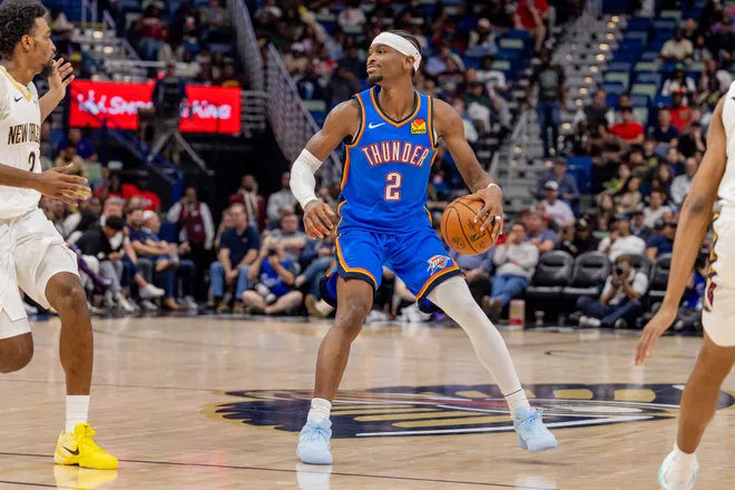 Nov 17, 2025; New Orleans, Louisiana, USA; Oklahoma City Thunder guard Shai Gilgeous-Alexander (2) dribbles against New Orleans Pelicans center Derik Queen (22) during the first half at Smoothie King Center. Mandatory Credit: Stephen Lew-Imagn Images