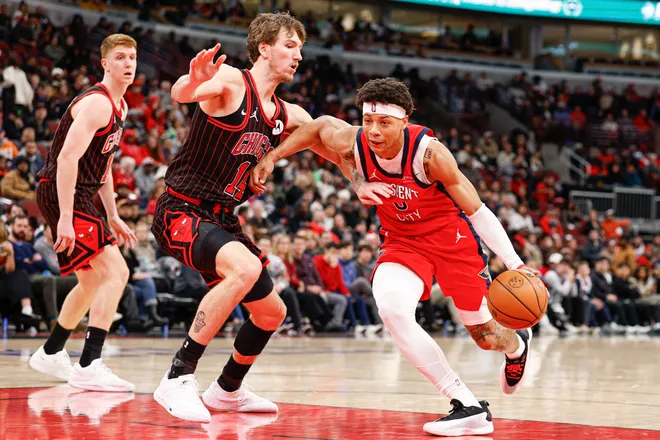 Dec 14, 2025; Chicago, Illinois, USA; New Orleans Pelicans guard Jeremiah Fears (0) drives to the basket against Chicago Bulls forward Matas Buzelis (14) during the second half at United Center. Mandatory Credit: Kamil Krzaczynski-Imagn Images