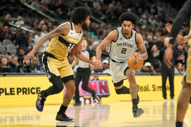Dec 18, 2025; San Antonio, Texas, USA; San Antonio Spurs guard Dylan Harper (2) drives to the basket against Washington Wizards forward Marvin Bagley III (35) during the first half at Frost Bank Center. Mandatory Credit: Scott Wachter-Imagn Images