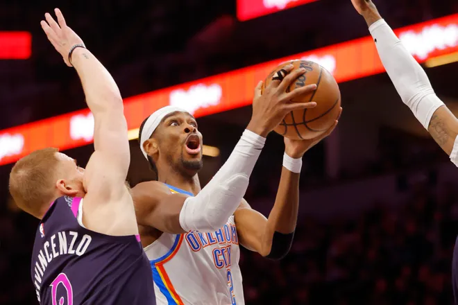 Dec 19, 2025; Minneapolis, Minnesota, USA; Oklahoma City Thunder guard Shai Gilgeous-Alexander (2) goes to the basket past Minnesota Timberwolves guard Donte DiVincenzo (0) in the first quarter at Target Center. Mandatory Credit: Bruce Kluckhohn-Imagn Images