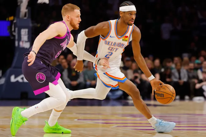 Dec 19, 2025; Minneapolis, Minnesota, USA; Oklahoma City Thunder guard Shai Gilgeous-Alexander (2) works past Minnesota Timberwolves guard Donte DiVincenzo (0) in the first quarter at Target Center. Mandatory Credit: Bruce Kluckhohn-Imagn Images