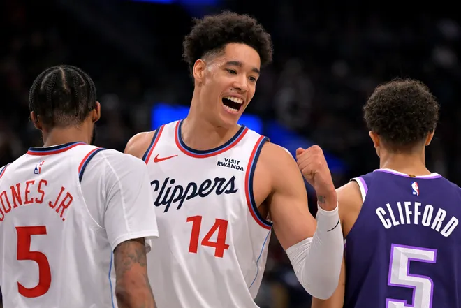 Dec 30, 2025; Inglewood, California, USA; Los Angeles Clippers center Yanic Konan Niederhauser (14) reacts aftera basket by forward Derrick Jones Jr. (5) in the first half against the Sacramento Kings at Intuit Dome. Mandatory Credit: Jayne Kamin-Oncea-Imagn Images