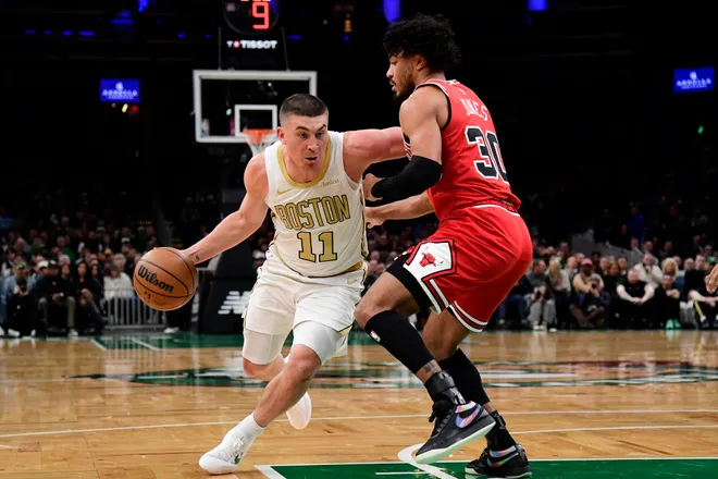 Jan 5, 2026; Boston, Massachusetts, USA; Boston Celtics guard Payton Pritchard (11) controls the ball while Chicago Bulls guard Tre Jones (30) defends during the first half at TD Garden. Mandatory Credit: Bob DeChiara-Imagn Images