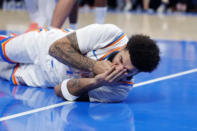 Jan 7, 2026; Oklahoma City, Oklahoma, USA; Oklahoma City Thunder guard/forward Kenrich Williams (34) grabs his face after getting hit during a drive against the Utah Jazz during the second half at Paycom Center. Mandatory Credit: Alonzo Adams-Imagn Images