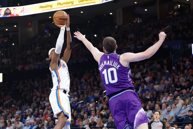 Jan 7, 2026; Oklahoma City, Oklahoma, USA; Oklahoma City Thunder guard Shai Gilgeous-Alexander (2) shoots as Utah Jazz guard/forward Svi Mykhailiuk (10) comes in to defend during the second quarter at Paycom Center. Mandatory Credit: Alonzo Adams-Imagn Images
