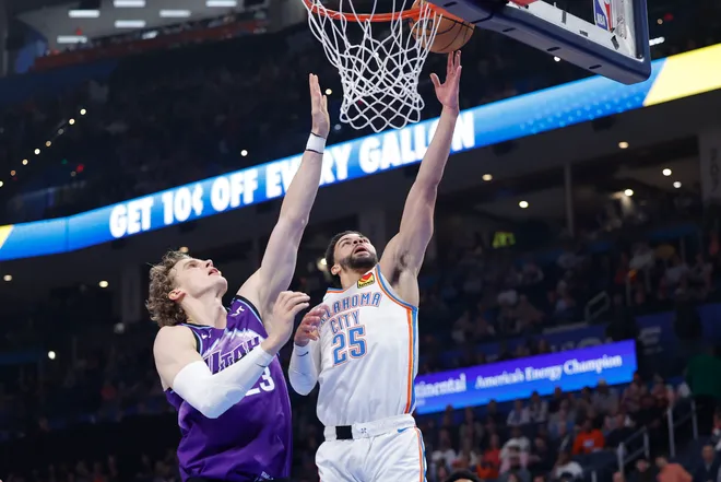 Jan 7, 2026; Oklahoma City, Oklahoma, USA; Oklahoma City Thunder guard Ajay Mitchell (25) goes up for a basket beside Utah Jazz forward/center Lauri Markkanen (23) during the second quarter at Paycom Center. Mandatory Credit: Alonzo Adams-Imagn Images