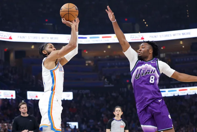 Jan 7, 2026; Oklahoma City, Oklahoma, USA; Oklahoma City Thunder guard Isaiah Joe (11) shoots as Utah Jazz guard Isaiah Collier (8) defends during the second quarter at Paycom Center. Mandatory Credit: Alonzo Adams-Imagn Images