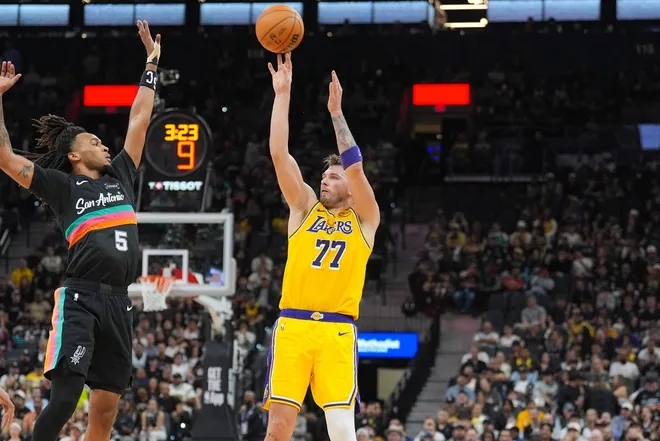 Jan 7, 2026; San Antonio, Texas, USA; Los Angeles Lakers forward/guard Luka Dončić (77) shoots over San Antonio Spurs guard Stephon Castle (5) in the second half at Frost Bank Center.