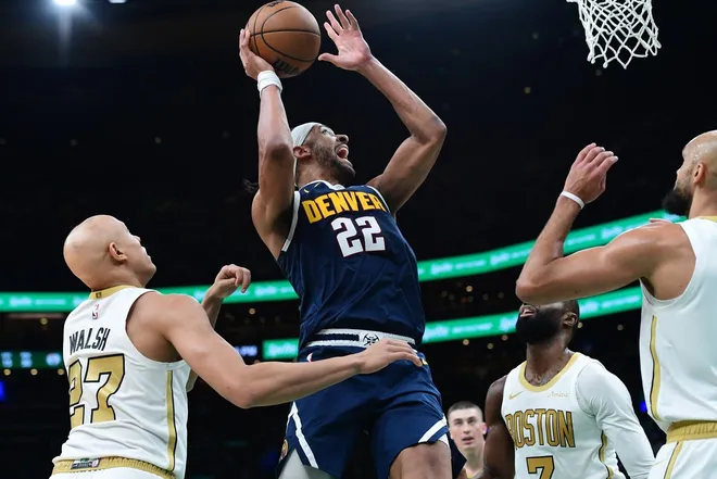 Jan 7, 2026; Boston, Massachusetts, USA; Denver Nuggets forward Zeke Nnaji (22) drives to the basket while Boston Celtics guard Jordan Walsh (27) and guard Derrick White (9) defend during the second half at TD Garden.