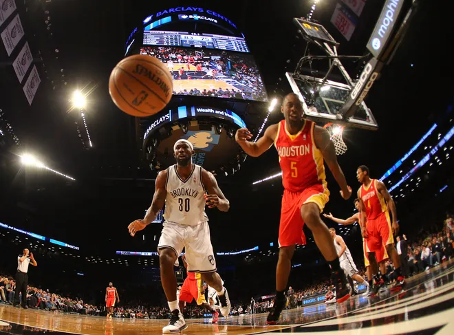 NEW YORK, NY - FEBRUARY 22: Reggie Evans #30 of the Brooklyn Nets and James Anderson #5 of the Houston Rockets fight for the ball during their game at the Barclays Center on February 22, 2013 in the Brooklyn borough of New York City. NOTE TO USER: User expressly acknowledges and agrees that, by downloading and/or using this photograph, user is consenting to the terms and conditions of the Getty Images License Agreement. (Photo by Al Bello/Getty Images)