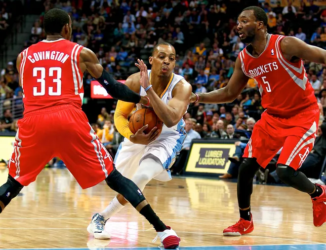 Apr 9, 2014; Denver, CO, USA; Denver Nuggets point guard Randy Foye (4) runs through the defense of Houston Rockets small forward Robert Covington (33) and small forward Jordan Hamilton (5) in the fourth quarter at the Pepsi Center. The Nuggets won 123-116. Mandatory Credit: Isaiah J. Downing-USA TODAY Sports