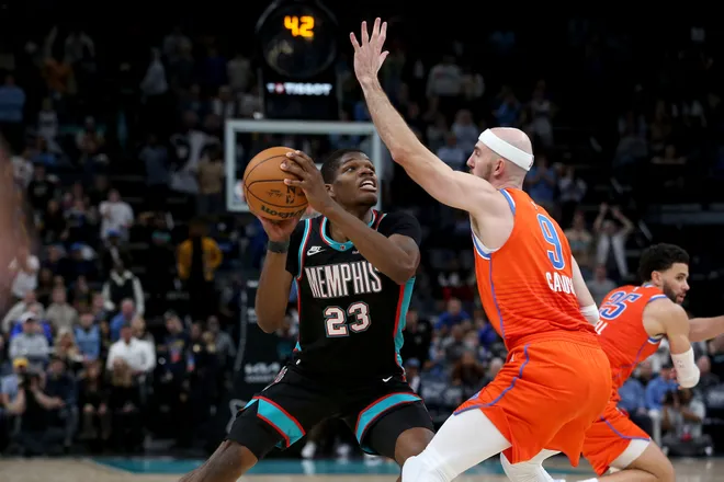 Jan 9, 2026; Memphis, Tennessee, USA; Memphis Grizzlies forward Cedric Coward (23) looks for an open shot in the final seconds of the the fourth quarter as Oklahoma City Thunder guard Alex Caruso (9) defends at FedExForum. Mandatory Credit: Petre Thomas-Imagn Images