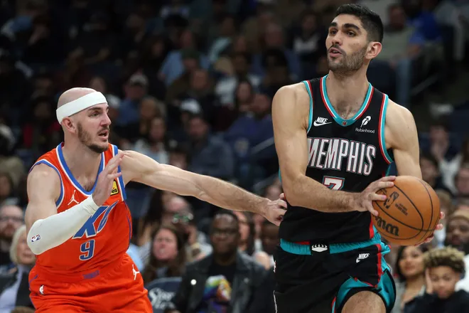 Jan 9, 2026; Memphis, Tennessee, USA; Memphis Grizzlies forward Santi Aldama (7) drives to the basket as Oklahoma City Thunder guard Alex Caruso (9) defends during the fourth quarter at FedExForum. Mandatory Credit: Petre Thomas-Imagn Images