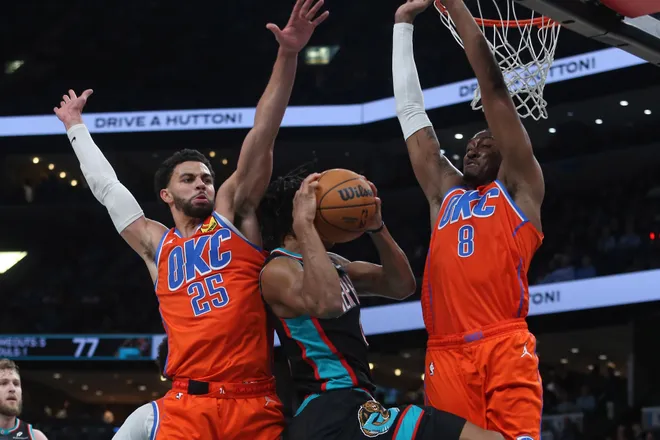 Jan 9, 2026; Memphis, Tennessee, USA; Oklahoma City Thunder guard Ajay Mitchell (25) and guard Jalen Williams (8) defends as Memphis Grizzlies forward Jaylen Wells (0) drives to the basket during the third quarter at FedExForum. Mandatory Credit: Petre Thomas-Imagn Images