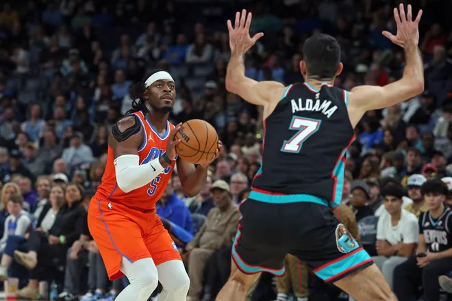 Jan 9, 2026; Memphis, Tennessee, USA; Oklahoma City Thunder guard Luguentz Dort (5) shoots for three as Memphis Grizzlies forward Santi Aldama (7) defends during the second quarter at FedExForum. Mandatory Credit: Petre Thomas-Imagn Images