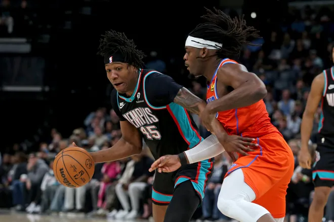 Jan 9, 2026; Memphis, Tennessee, USA; Memphis Grizzlies forward GG Jackson II (45) dribbles as Oklahoma City Thunder guard Luguentz Dort (5) defends during the third quarter at FedExForum. Mandatory Credit: Petre Thomas-Imagn Images
