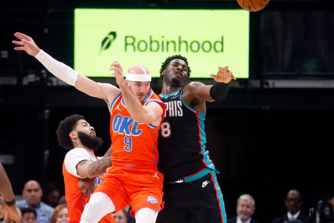 Jan 9, 2026; Memphis, Tennessee, USA; Oklahoma City Thunder guard Alex Caruso (9) and Memphis Grizzlies forward/center Jaren Jackson Jr. (8) battle for the ball during the second quarter at FedExForum. Mandatory Credit: Petre Thomas-Imagn Images