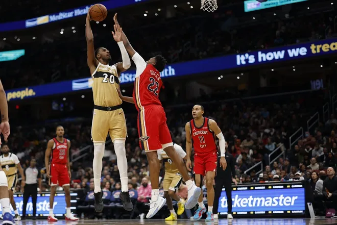 Jan 9, 2026; Washington, District of Columbia, USA; Washington Wizards center Alex Sarr (20) shoots the ball over New Orleans Pelicans center Derik Queen (22) in the second half at Capital One Arena.