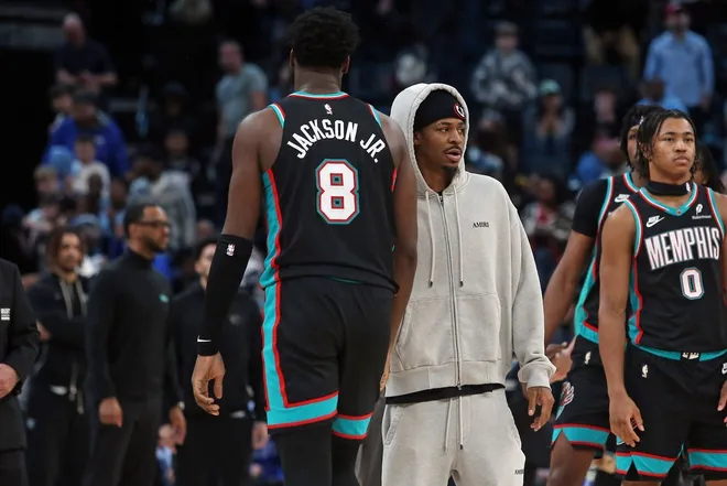 Jan 9, 2026; Memphis, Tennessee, USA; Memphis Grizzlies guard Ja Morant (right) reacts with Memphis Grizzlies forward/center Jaren Jackson Jr. (8) after the game against the Oklahoma City Thunder at FedExForum.