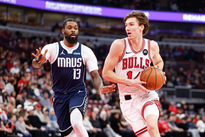 Jan 10, 2026; Chicago, Illinois, USA; Chicago Bulls forward Matas Buzelis (14) drives to the basket against Dallas Mavericks forward Naji Marshall (13) during the first half at United Center. Mandatory Credit: Kamil Krzaczynski-Imagn Images