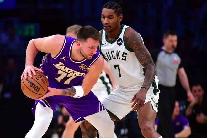 Jan 9, 2026; Los Angeles, California, USA; Los Angeles Lakers guard Luka Doncic (77) moves the ball against Milwaukee Bucks guard Kevin Porter Jr. (7) during the first half at Crypto.com Arena. Mandatory Credit: Gary A. Vasquez-Imagn Images