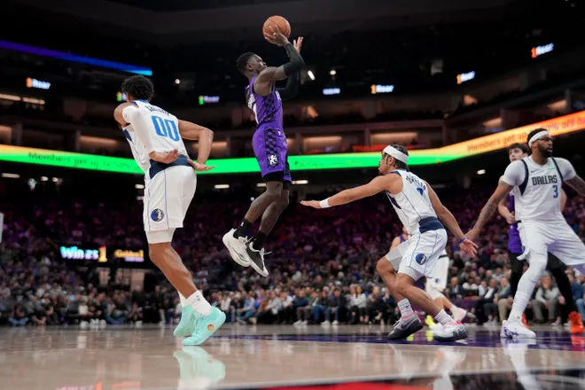 Jan 6, 2026; Sacramento, California, USA; Sacramento Kings guard Dennis Schroder (17) makes a shot over Dallas Mavericks guard Ryan Nembhard (9) in the fourth quarter at the Golden 1 Center. Mandatory Credit: Cary Edmondson-Imagn Images