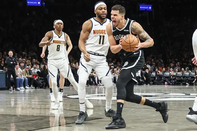 Jan 4, 2026; Brooklyn, New York, USA; Brooklyn Nets forward Michael Porter Jr. (17) looks to drive past Denver Nuggets guard Bruce Brown (11) in the third quarter at Barclays Center. Mandatory Credit: Wendell Cruz-Imagn Images