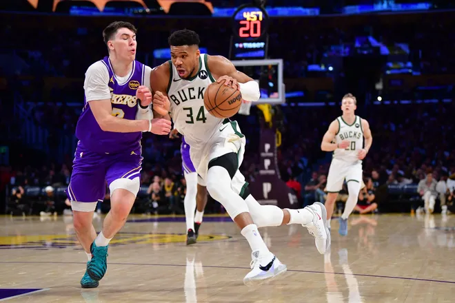 Jan 9, 2026; Los Angeles, California, USA; Milwaukee Bucks forward Giannis Antetokounmpo (34) moves the ball against Los Angeles Lakers forward Jake LaRavia (12) during the first half at Crypto.com Arena. Mandatory Credit: Gary A. Vasquez-Imagn Images