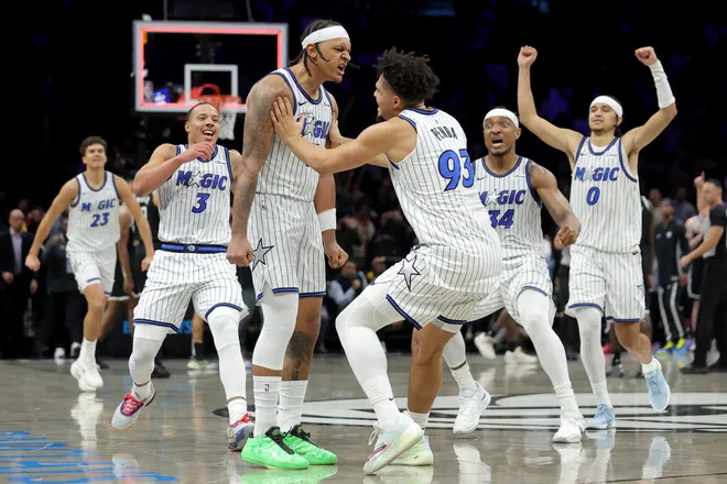 Jan 7, 2026; Brooklyn, New York, USA; Orlando Magic forward Paolo Banchero (5) celebrates his overtime game-winning three point shot against the Brooklyn Nets with guard Desmond Bane (3) and forward Noah Penda (93) and center Wendell Carter Jr. (34) and guard Anthony Black (0) at Barclays Center. Mandatory Credit: Brad Penner-Imagn Images