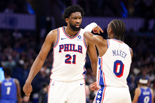 Jan 9, 2026; Orlando, Florida, USA; Philadelphia 76ers center Joel Embiid (21) reacts to guard Tyrese Maxey (0) against the Orlando Magic in the third quarter at Kia Center. Mandatory Credit: Nathan Ray Seebeck-Imagn Images