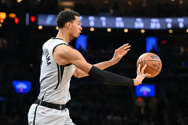 Jan 10, 2026; Boston, Massachusetts, USA; San Antonio Spurs forward Victor Wembanyama (1) passes the ball against the Boston Celtics during the first half at the TD Garden. Mandatory Credit: Brian Fluharty-Imagn Images