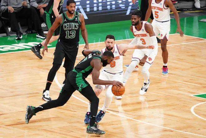 Jan 17, 2021; Boston, Massachusetts, USA; Boston Celtics guard Jaylen Brown (7) drives the ball against New York Knicks guard Austin Rivers (8) in the fourth quarter at TD Garden. Mandatory Credit: David Butler II-USA TODAY Sports