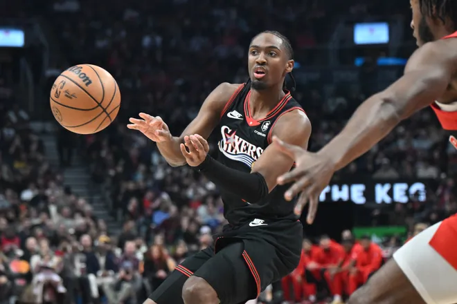 Jan 11, 2026; Toronto, Ontario, CAN; Philadelphia 76ers guard Tyrese Maxey (0) passes the ball away from Toronto Raptors guard Immanuel Quickley (5) in the first half at Scotiabank Arena. Mandatory Credit: Dan Hamilton-Imagn Images