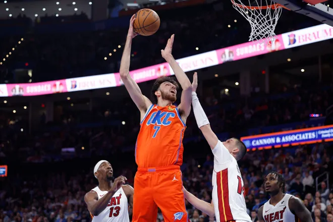 Jan 11, 2026; Oklahoma City, Oklahoma, USA; Oklahoma City Thunder center/forward Chet Holmgren (7) goes up for a basket over Miami Heat guard Tyler Herro (14) during the second half at Paycom Center. Mandatory Credit: Alonzo Adams-Imagn Images