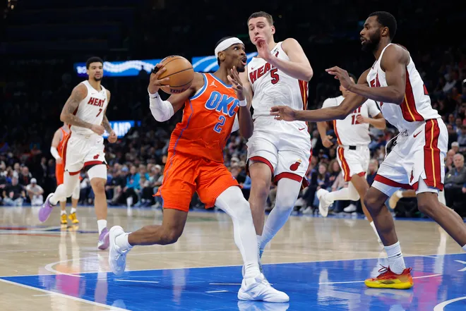 Jan 11, 2026; Oklahoma City, Oklahoma, USA; Oklahoma City Thunder guard Shai Gilgeous-Alexander (2) drives to the basket around Miami Heat forward Nikola Jović (5) during the second half at Paycom Center. Mandatory Credit: Alonzo Adams-Imagn Images