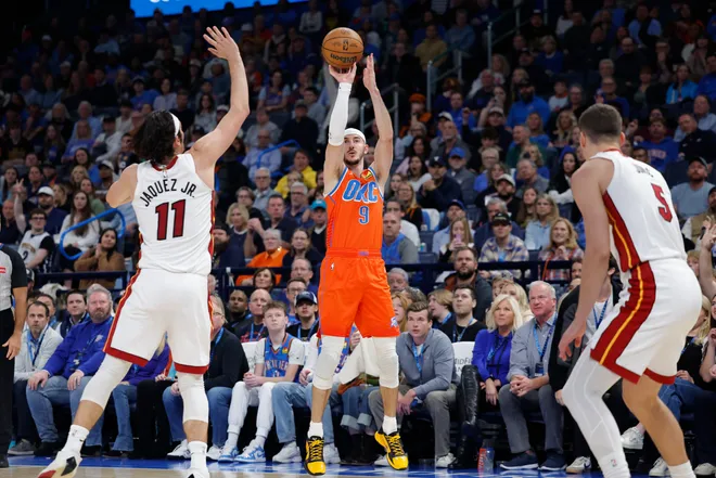 Jan 11, 2026; Oklahoma City, Oklahoma, USA; Oklahoma City Thunder guard Alex Caruso (9) shoots a three point basket against the Miami Heat during the second half at Paycom Center. Mandatory Credit: Alonzo Adams-Imagn Images