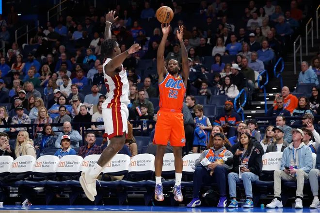 Jan 11, 2026; Oklahoma City, Oklahoma, USA; Oklahoma City Thunder guard Cason Wallace (22) shoots a three point basket against the Miami Heat during the second half at Paycom Center. Mandatory Credit: Alonzo Adams-Imagn Images