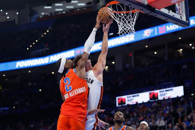 Jan 11, 2026; Oklahoma City, Oklahoma, USA; Oklahoma City Thunder guard Shai Gilgeous-Alexander (2) blocks a shot by Miami Heat guard Pelle Larsson (9) during the second quarter at Paycom Center. Mandatory Credit: Alonzo Adams-Imagn Images