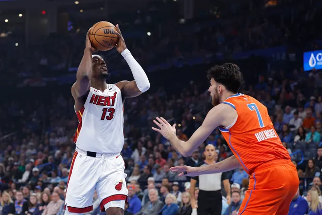 Jan 11, 2026; Oklahoma City, Oklahoma, USA; Miami Heat center/forward Bam Adebayo (13) drives to the basket against Oklahoma City Thunder center/forward Chet Holmgren (7) during the first quarter at Paycom Center. Mandatory Credit: Alonzo Adams-Imagn Images
