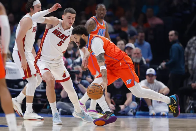 Jan 11, 2026; Oklahoma City, Oklahoma, USA; Oklahoma City Thunder guard/forward Kenrich Williams (34) drives to the basket around Miami Heat forward Nikola Jović (5) during the second quarter at Paycom Center. Mandatory Credit: Alonzo Adams-Imagn Images