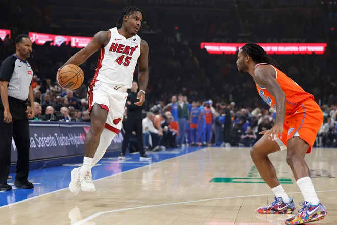 Jan 11, 2026; Oklahoma City, Oklahoma, USA; Miami Heat guard Davion Mitchell (45) moves the ball down the court beside Oklahoma City Thunder guard Cason Wallace (22) during the first quarter at Paycom Center. Mandatory Credit: Alonzo Adams-Imagn Images
