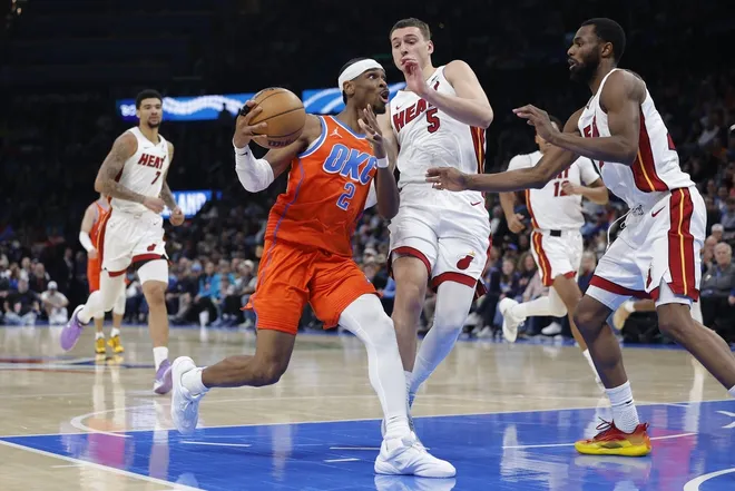 Jan 11, 2026; Oklahoma City, Oklahoma, USA; Oklahoma City Thunder guard Shai Gilgeous-Alexander (2) drives to the basket around Miami Heat forward Nikola Jović (5) during the second half at Paycom Center.