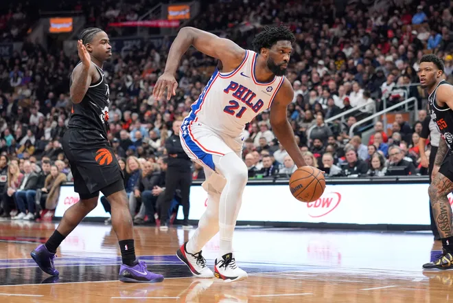 Jan 12, 2026; Toronto, Ontario, CAN; Philadelphia 76ers center Joel Embiid (21) dribbles past Toronto Raptors guard Jamal Shead (23) during the first half at Scotiabank Arena. Mandatory Credit: John E. Sokolowski-Imagn Images