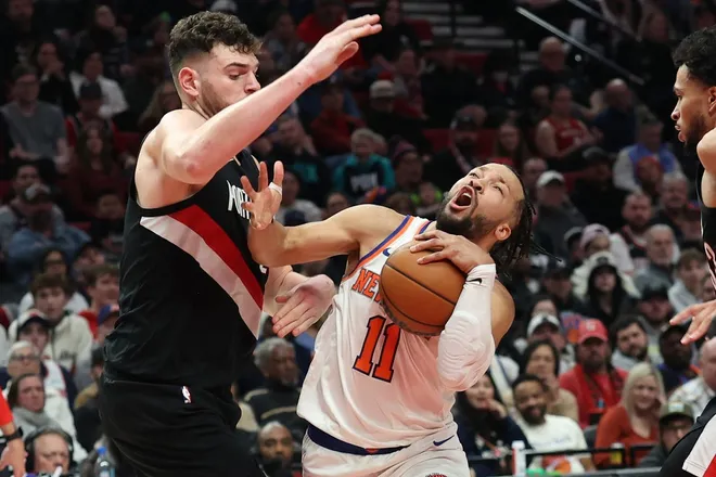 Jan 11, 2026; Portland, Oregon, USA; New York Knicks guard Jalen Brunson (11) drives to the basket past Portland Trail Blazers center Donovan Clingan (23) and forward Toumani Camara (33) during the second half at Moda Center.