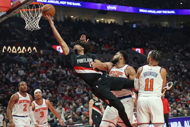 Jan 11, 2026; Portland, Oregon, USA; Portland Trail Blazers guard Shaedon Sharpe (17)] shoots the ball over New York Knicks center/forward Karl-Anthony Towns (32) during the first half at Moda Center.