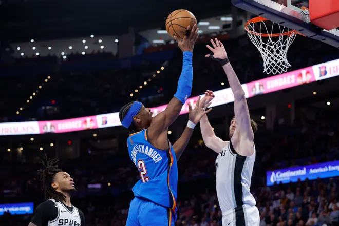 Jan 13, 2026; Oklahoma City, Oklahoma, USA; Oklahoma City Thunder guard Shai Gilgeous-Alexander (2) goes up for a basket against San Antonio Spurs center/forward Luke Kornet (7) during the second half at Paycom Center. Mandatory Credit: Alonzo Adams-Imagn Images
