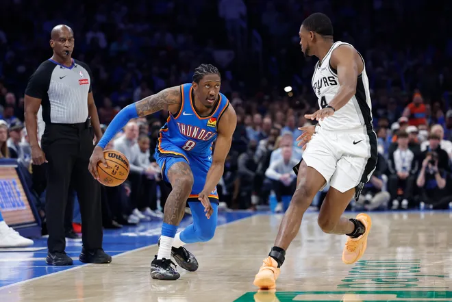 Jan 13, 2026; Oklahoma City, Oklahoma, USA; Oklahoma City Thunder guard/forward Jalen Williams (8) drives down the court beside San Antonio Spurs guard De'aaron Fox (4) during the second half at Paycom Center. Mandatory Credit: Alonzo Adams-Imagn Images